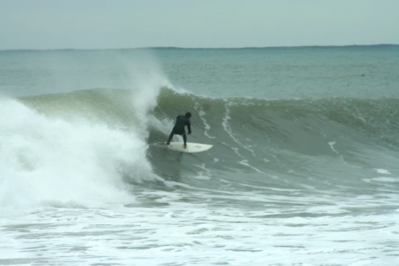 a surfer on a surf board riding a wave