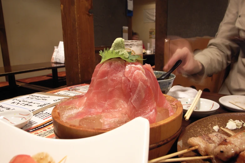 a table with food on it and some chop sticks in the middle