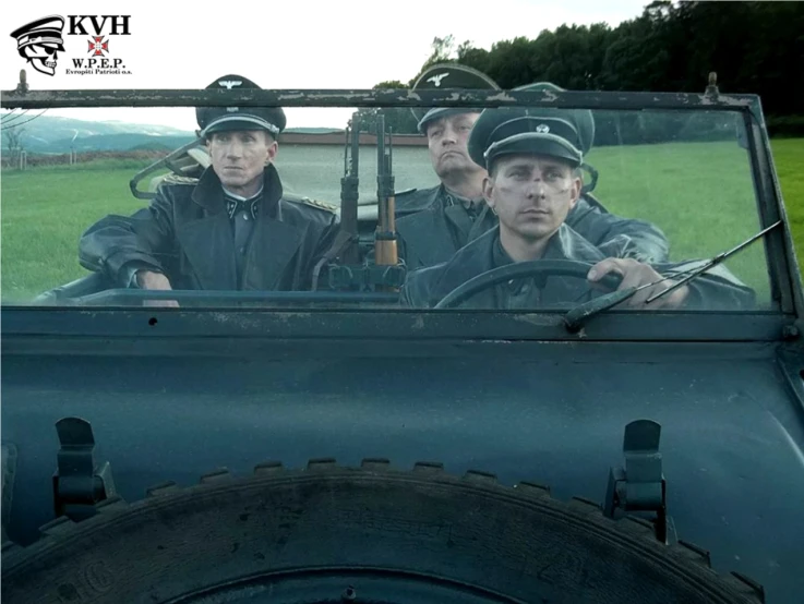 three men driving a truck with an open top in the street