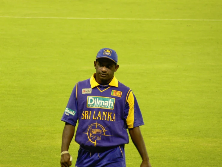 the player in purple and yellow uniform walks towards the camera