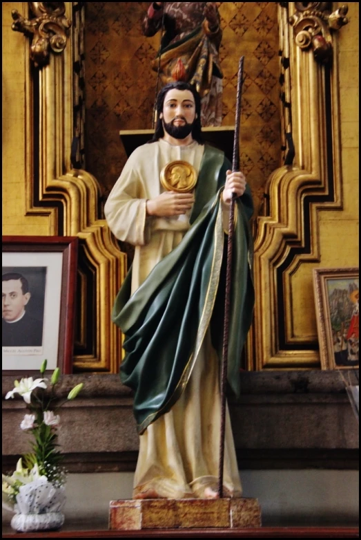 the statue shows christ holding a gold medal