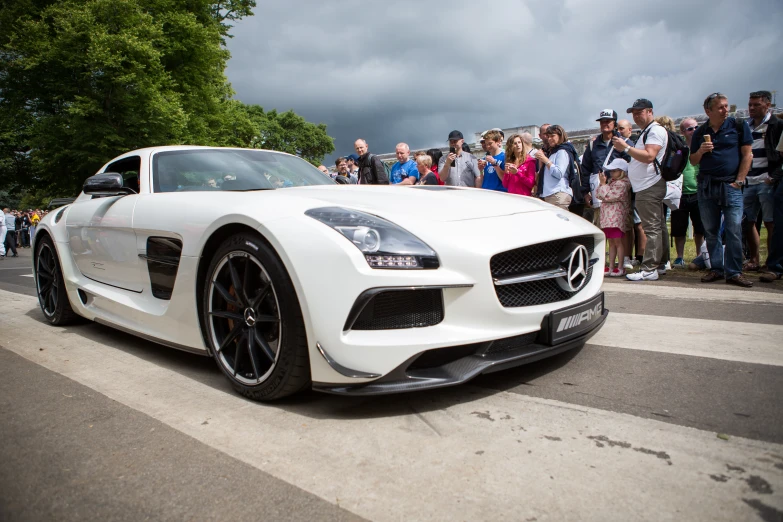 people are watching the car in front of it