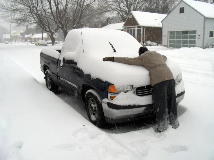 a person is working on the car in the snow