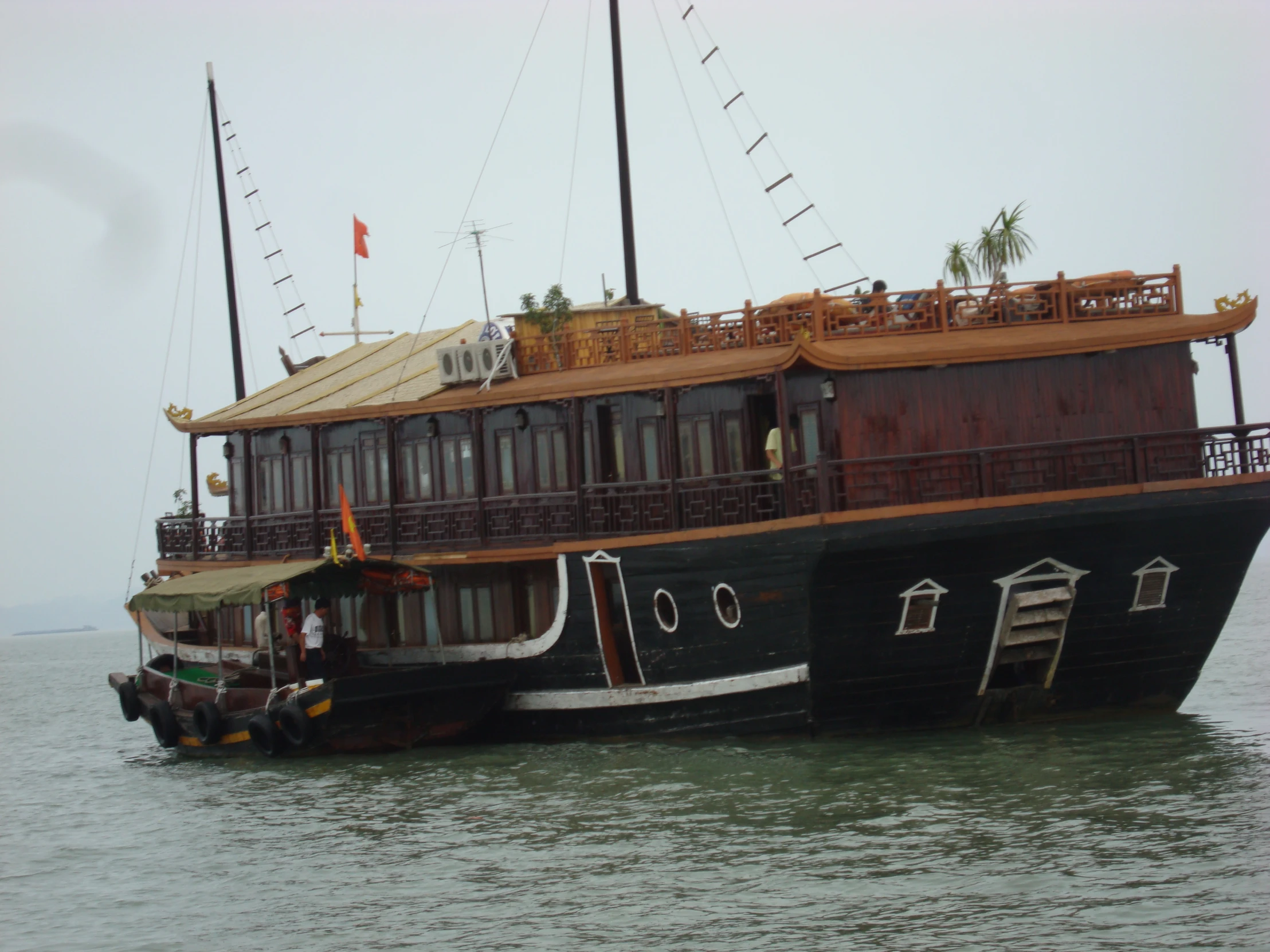 a large black ship with wooden balconies and windows