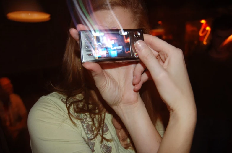 a woman takes a picture with her cellphone