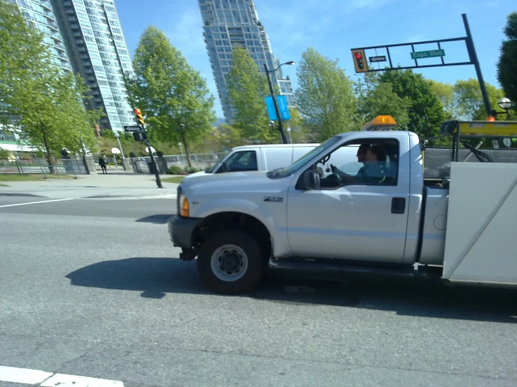 a white truck with yellow on its fender and cab