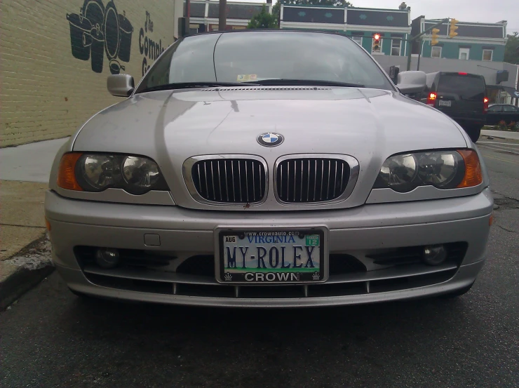 a silver car is parked in front of a house