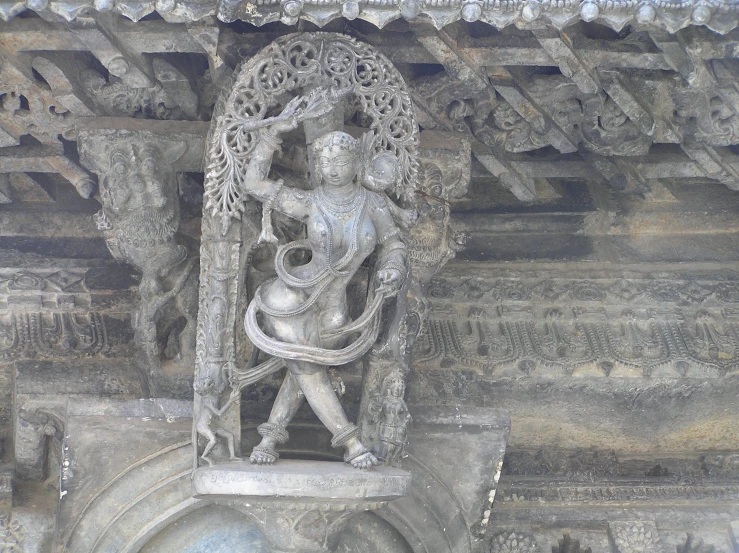 a marble statue with many carvings on the wall