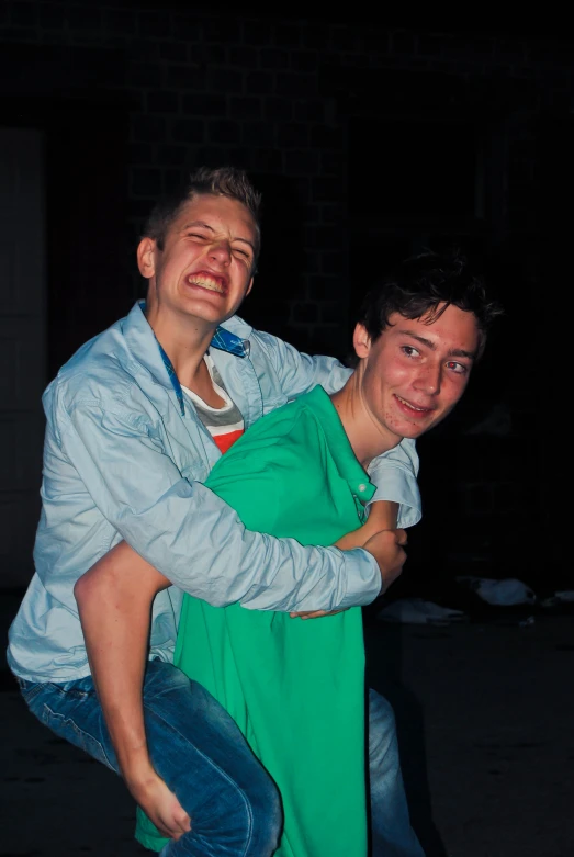 a man in an apron holding onto another mans shoulders