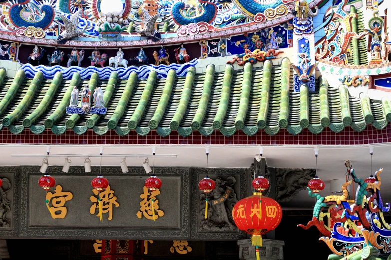 colorful asian ornaments and paintings on the roof of a building