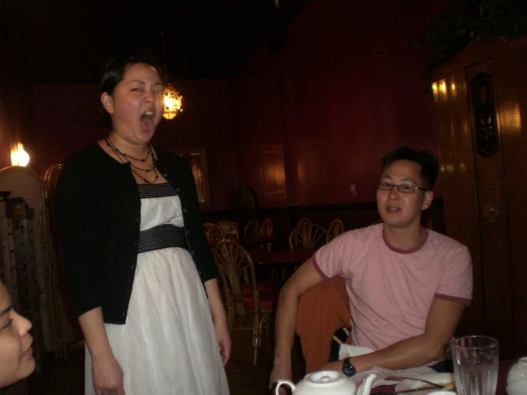 some friends are having an awkward conversation at a dining table