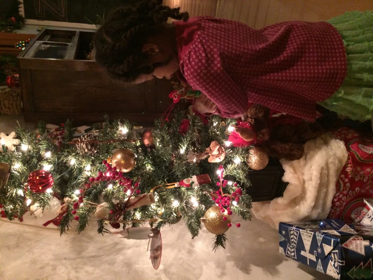 two little girls decorating a christmas tree together