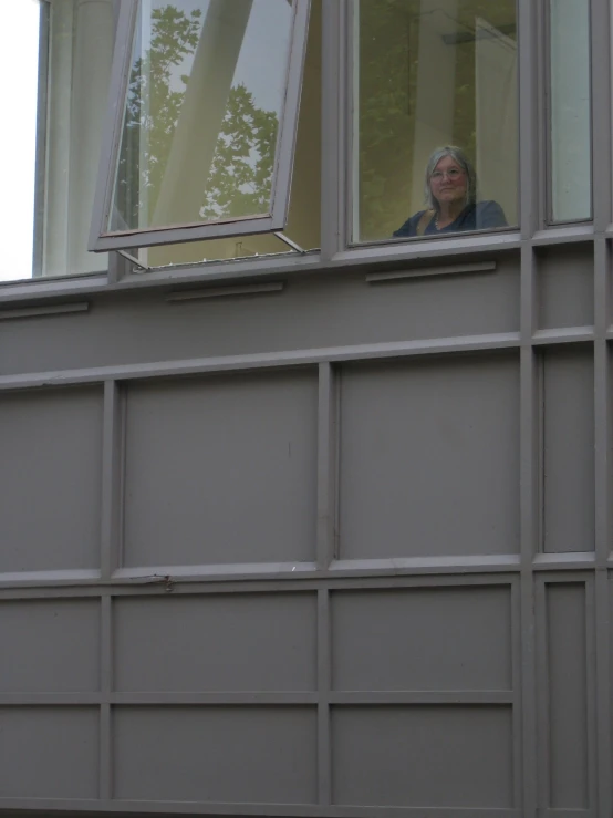 an old man is reflected in a window