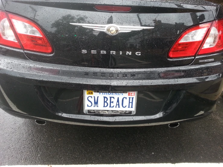 a small white license plate with some silver lettering