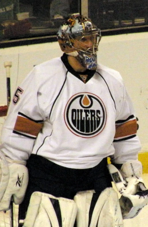 a person wearing a goalie suit with the logo of an oilers