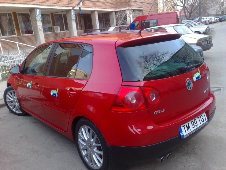 a red golf that has it's hood out and the door open