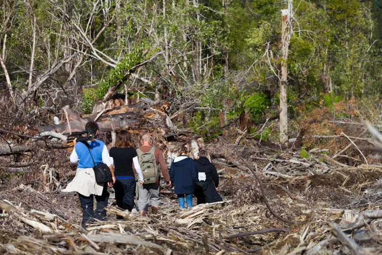 people are standing next to each other near some sticks