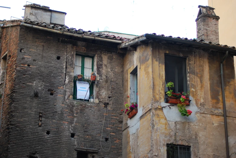 an old brick building with flowers in each window