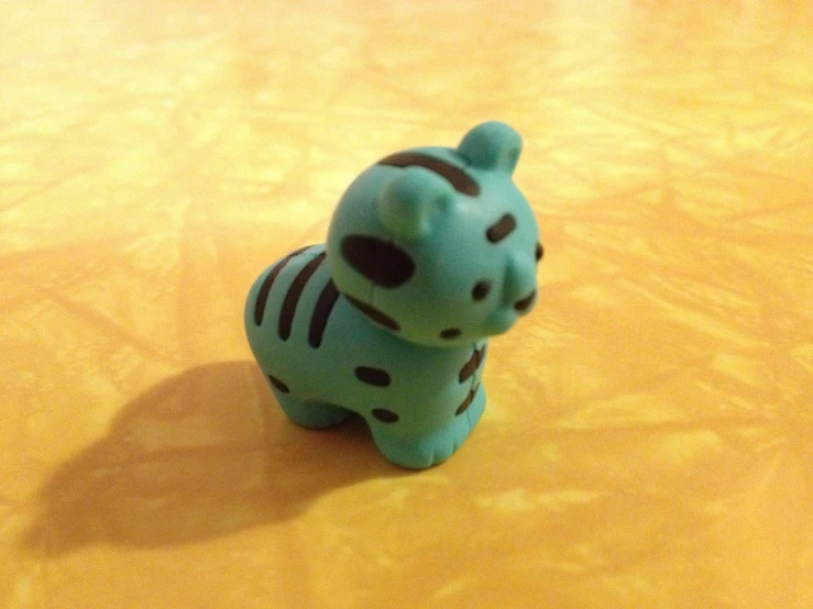 a small plastic blue toy tiger on a table