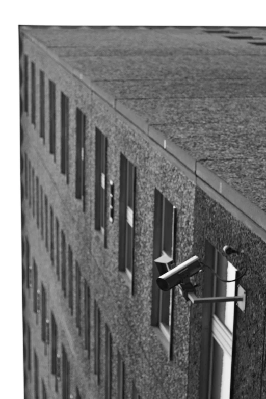 black and white pograph of a camera on top of a building
