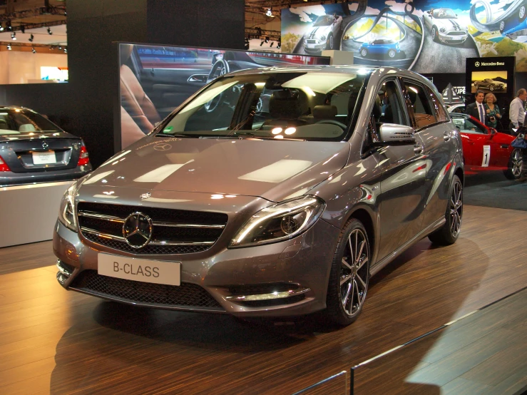 a gray car sitting on top of a wooden floor