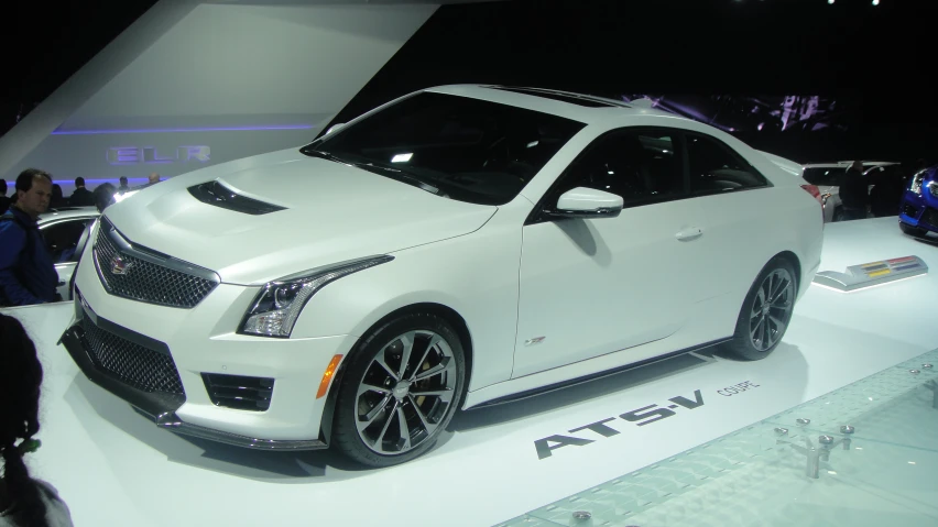 a white and black car on display at the booth