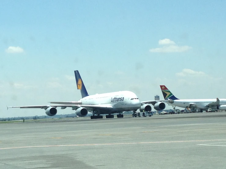 three air planes lined up on the runway