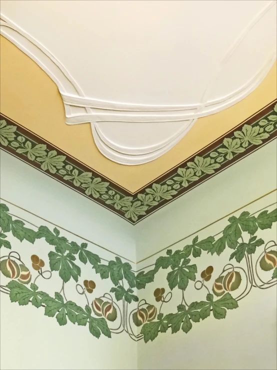 the corner of a bathroom with decorative wall paper