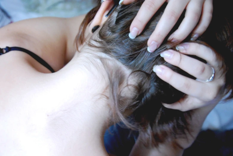 a woman that is laying down with a hair piece