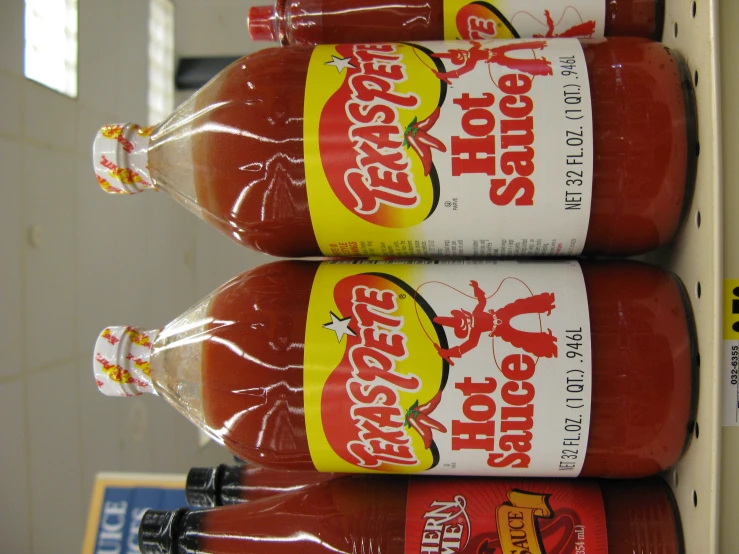 some bottles of  sauce for sale at a market