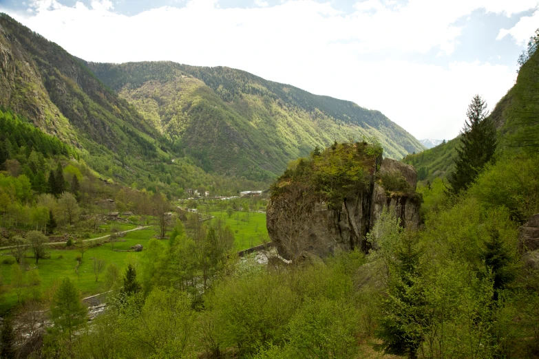 a valley in a mountain with lush green trees