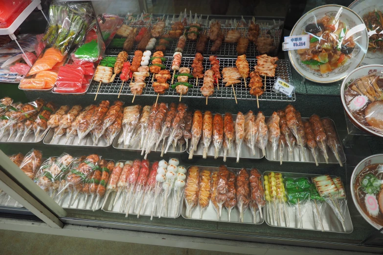 various food items on trays in a display case
