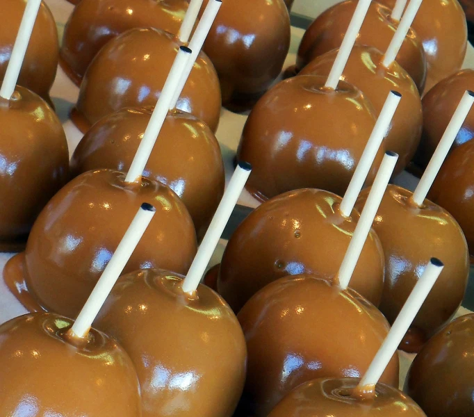 some caramel coated apples are on the tray