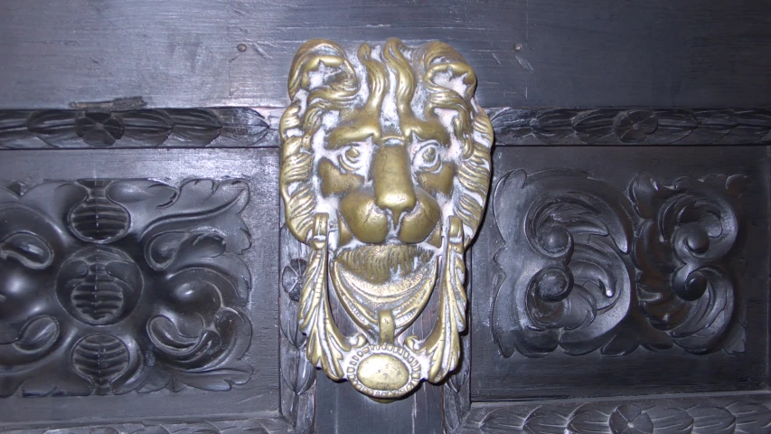 lion head sculpture on the wall of the building