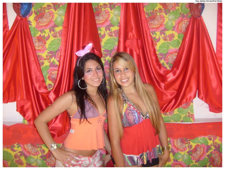 two girls in colorful dresses standing together