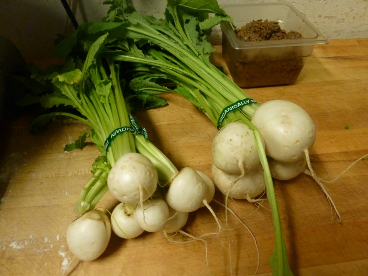 there are two green leaves and two turnips on the counter