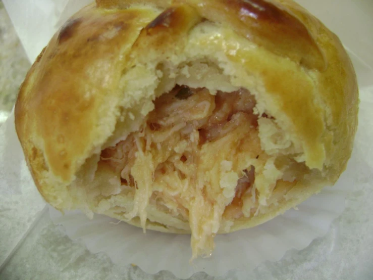 a pastry sitting on top of paper on a table