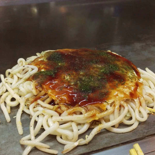 noodles with sauce and spices in a pan on a stove top