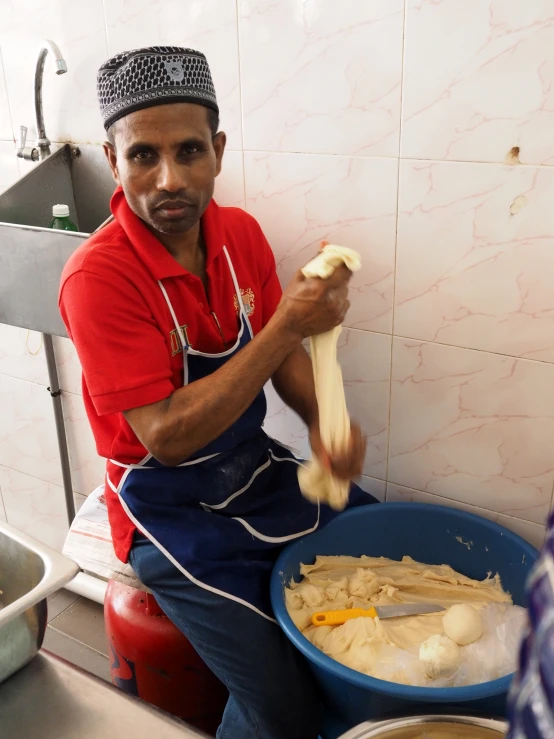 a man in the kitchen slicing onions and making pasta