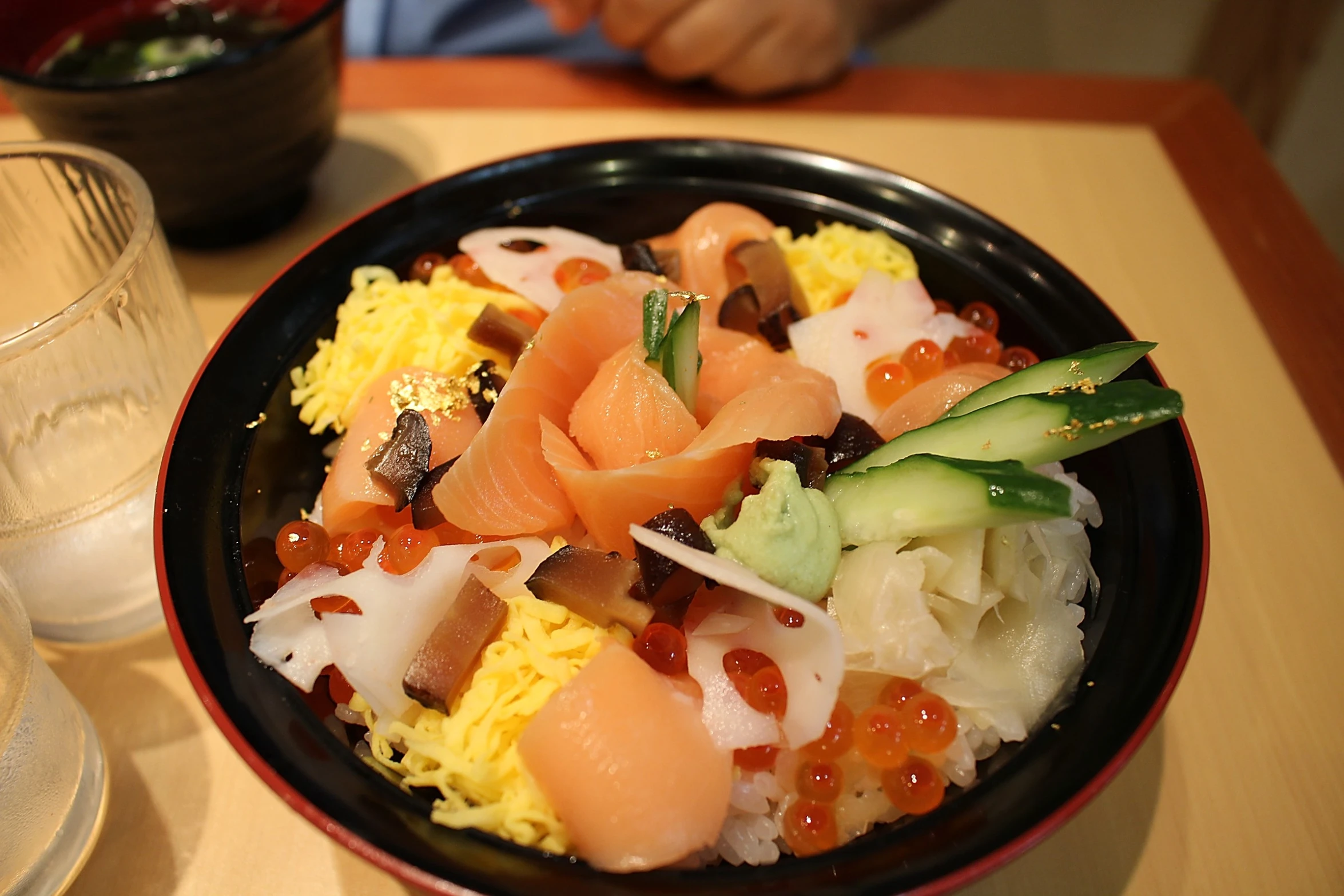 a small bowl of food with a glass next to it