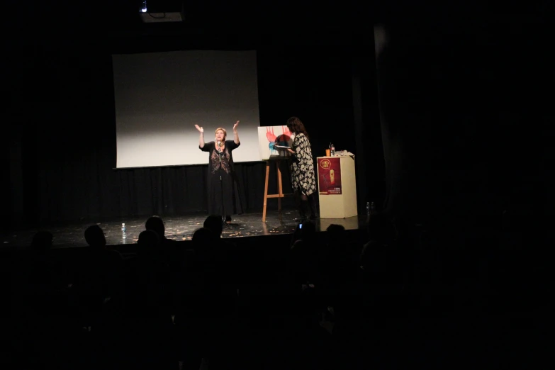 an older couple on stage at a theater