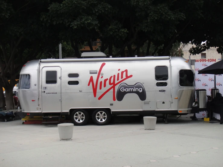 a silver trailer with an advertising sticker painted on it