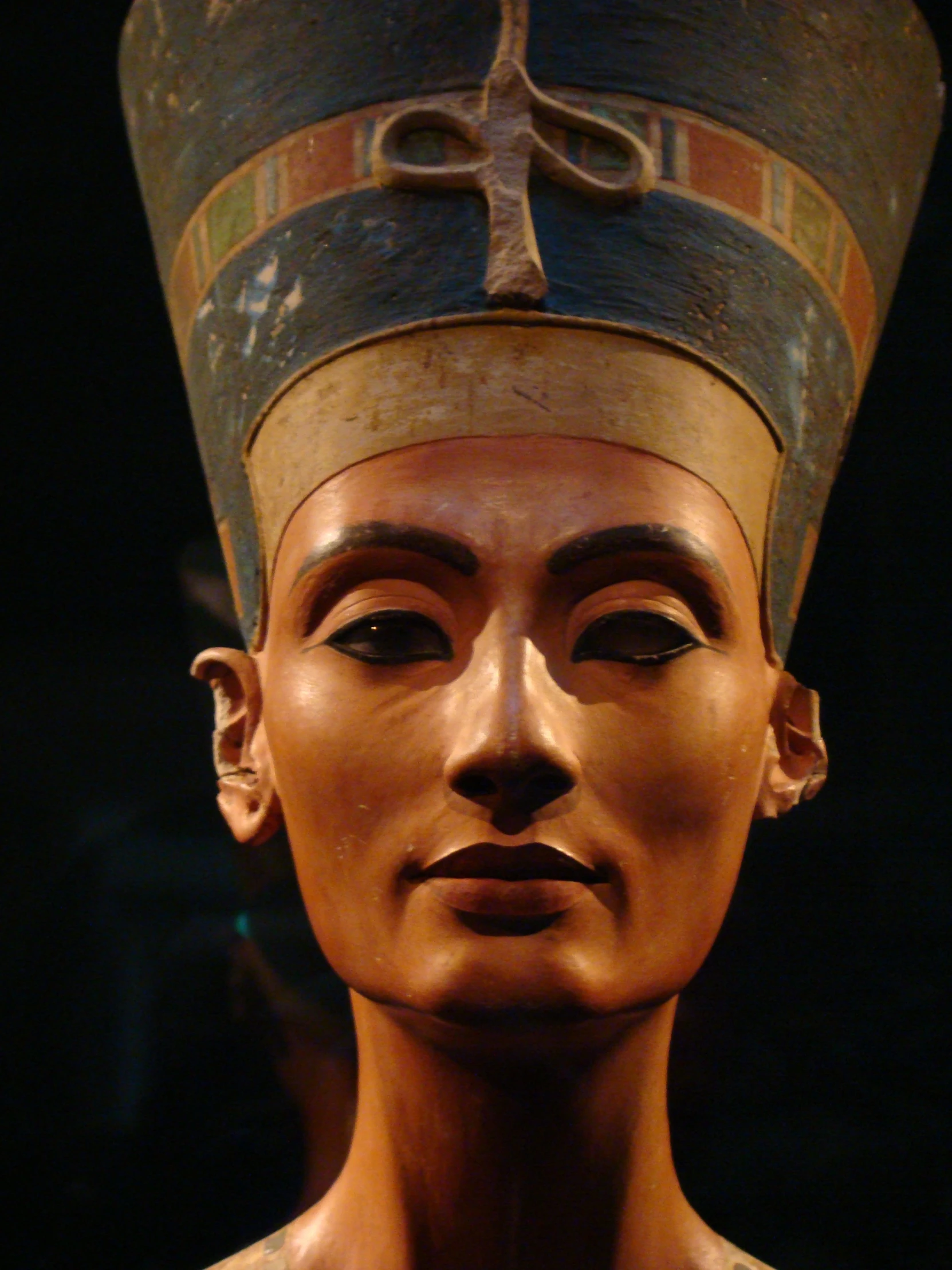 an ancient bust sculpture with a hat on top of it