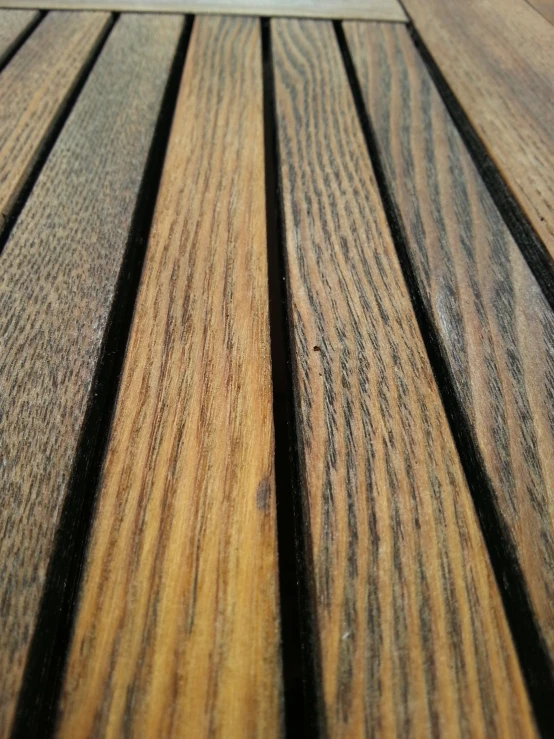 the surface of a wooden deck with different colored planks