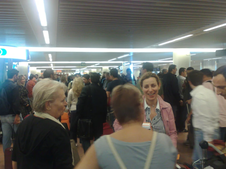 group of people at an airport with luggage