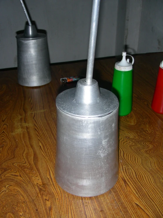 three different size and metal utensils sit on the floor