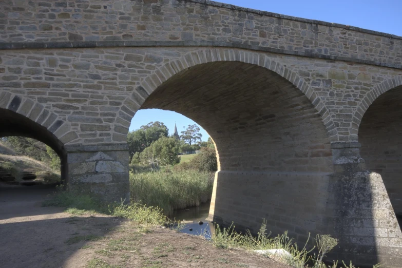 two old stone arches are in the ground