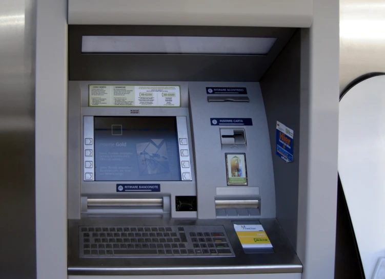 an atm machine with two machine keys attached to it