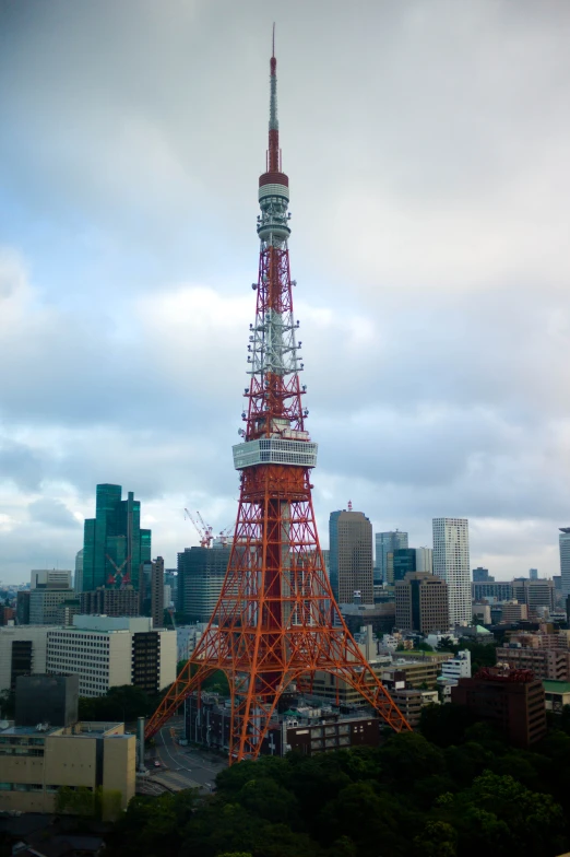 a large orange metal tower on top of some tall buildings