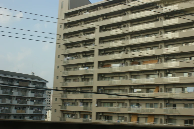 a tall grey building next to power lines